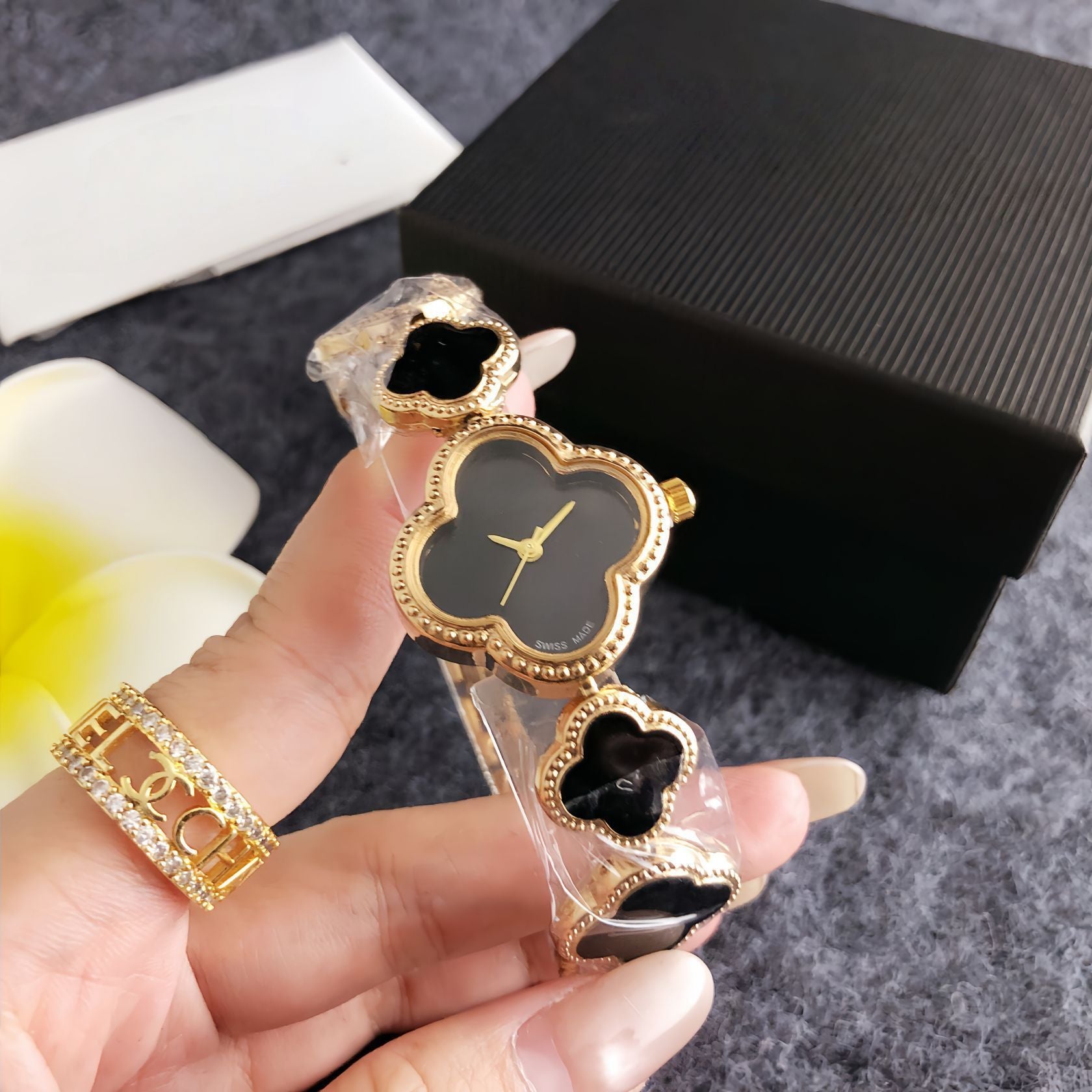 Four-leaf clover diamond-accented women's watch - silver case, black dial design - perfect for dates and commuting - elegant bracelet quartz wristwatch
