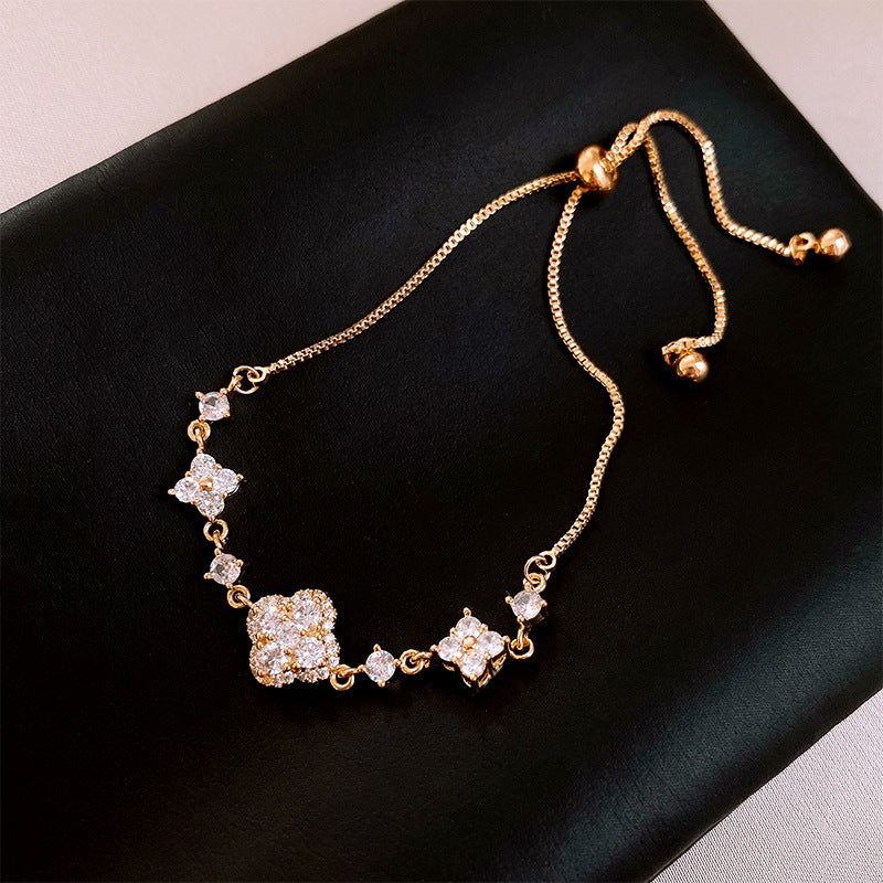 Four-petal zircon flower bracelet - elegant, adjustable, and trendy new jewelry