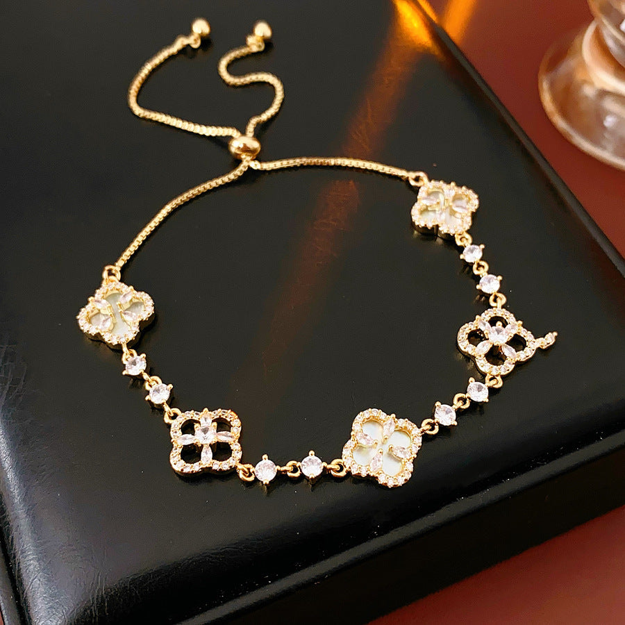 Four-petal zircon flower bracelet - elegant, adjustable, and trendy new jewelry