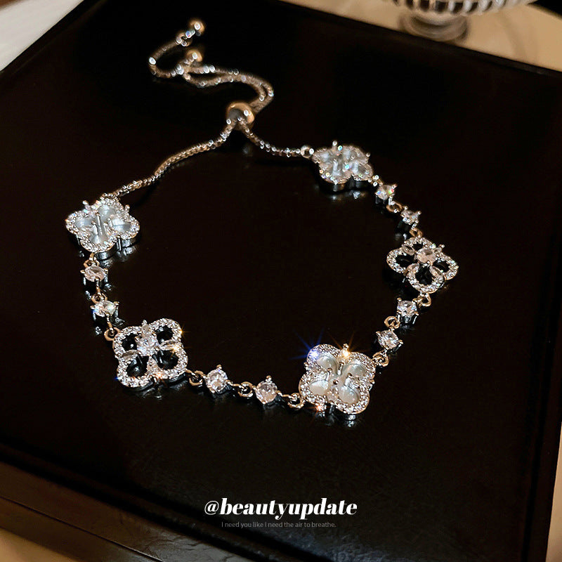 Four-petal zircon flower bracelet - elegant, adjustable, and trendy new jewelry