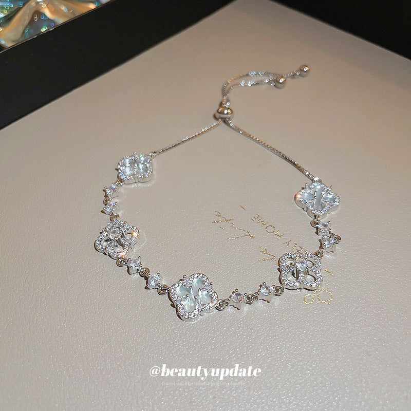 Four-petal zircon flower bracelet - elegant, adjustable, and trendy new jewelry